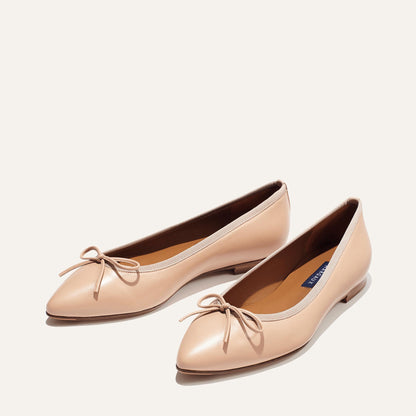 The Pointe in Rose Nappa, a classic and comfortable ballet flat featuring a refined pointed toe design and decorative bow. 