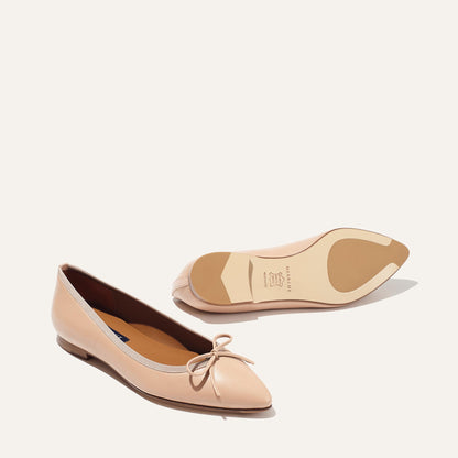 The Pointe in Rose Nappa, a classic and comfortable ballet flat featuring a refined pointed toe design and decorative bow. 