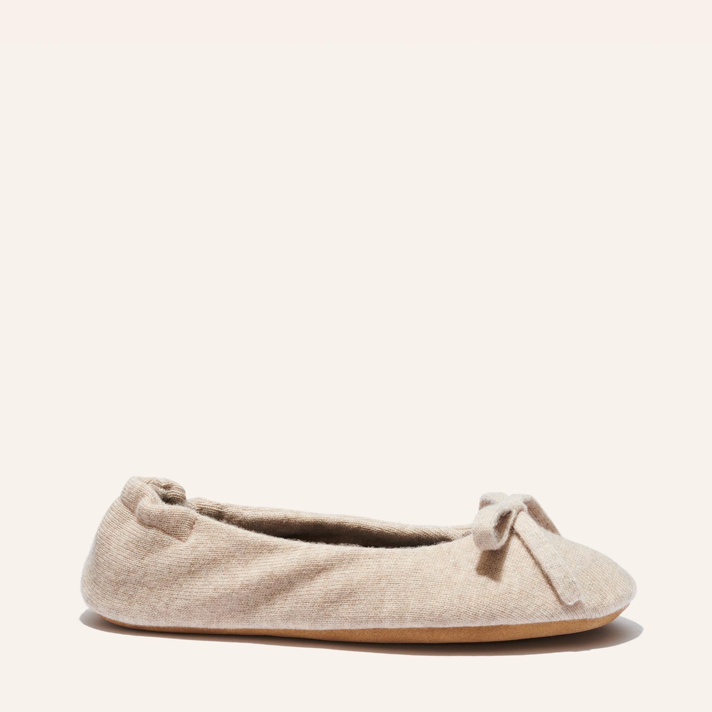 The Ballet Slipper - Oatmeal by Margaux: a cozy beige wool-cashmere flat with a delicate toe bow, displayed on a simple background—an ideal choice for relaxed comfort.