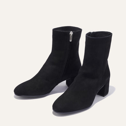 The Boot in Black Suede, featuring an elegant almond toe and block heel, crafted from high-quality Italian leather for a timeless and modern look.