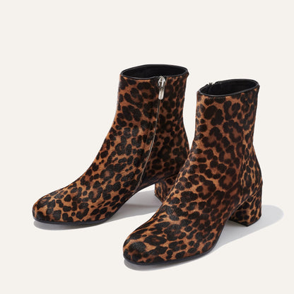 The Boot - Chocolate Leopard Haircalf by Margaux is an ankle-high, almond-toe boot with a chunky heel, brown and black leopard print, and side zippers for easy wear.