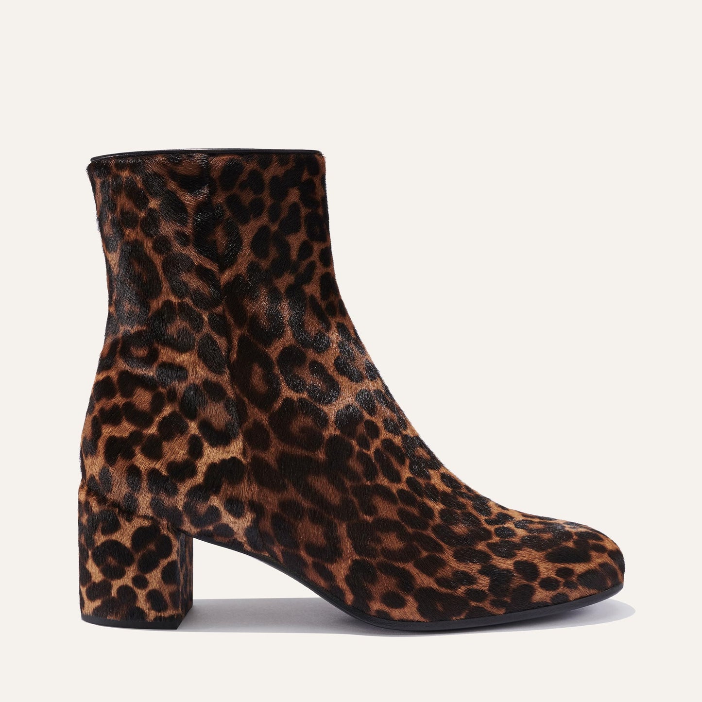 The Boot - Chocolate Leopard Haircalf by Margaux is an almond-toe, chunky-heeled boot in a brown and black leopard print, shown against a simple light background.