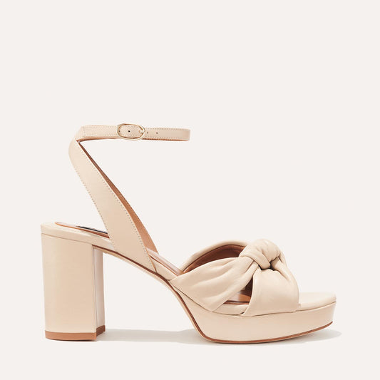 Margaux's Carmine Platform in ivory nappa leather with a knot detail and comfortable high heel