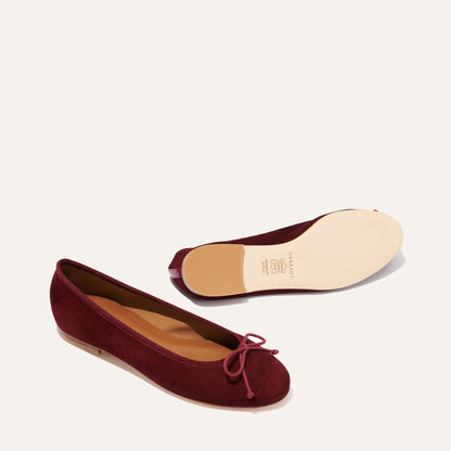 The Demi - Mulberry Suede by margaux-development: bestselling ballet flats in rich burgundy suede with a bow on the toe; one shoe is upright, showing top and side, the other upside down to reveal the smooth beige sole.