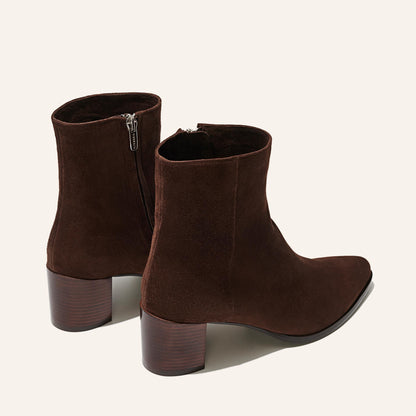 The Downtown Boot in Chocolate Suede, a chic ankle-height design complete with a Western-inspired welt and a comfortable 2.5-inch stacked heel.