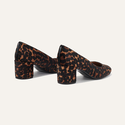 The Heel in Chocolate Leopard Haircalf, a classic block heel featuring a sleek almond toe design complemented by a comfortable 2.5-inch heel.