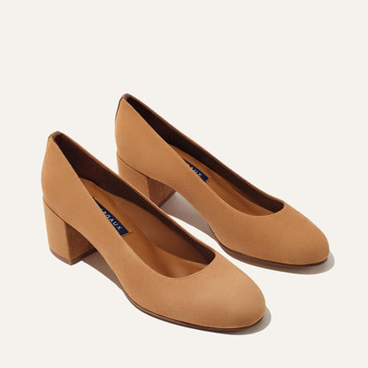 The Heel - Cacao Suede by Margaux: a pair of tan suede women's block-heeled shoes with a round toe and low, comfortable heel, shown against a plain light background.