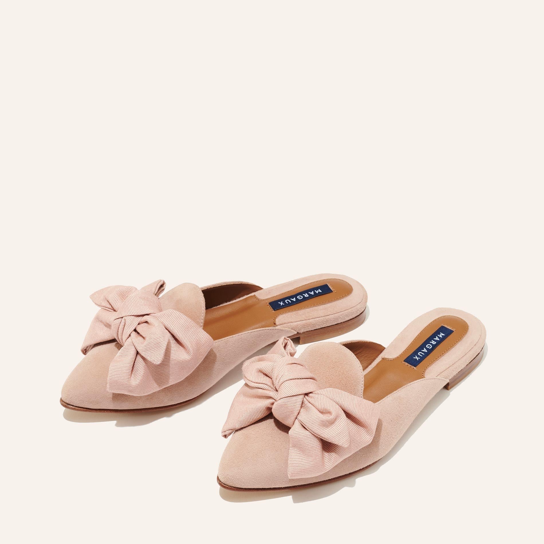 Margaux's classic and comfortable Mule, made in Spain from soft pink suede and finished with a rose grosgrain bow