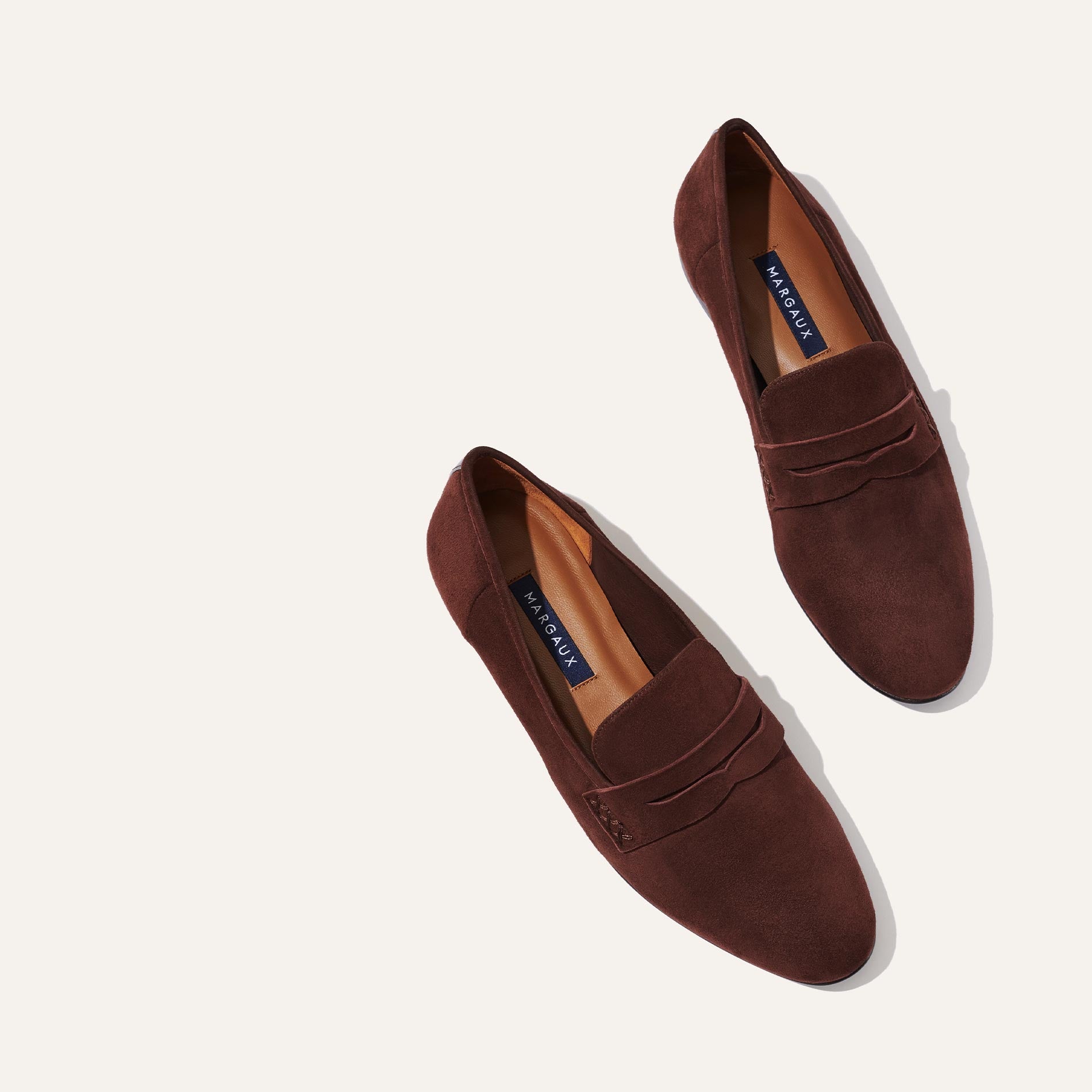 Margaux's classic and comfortable Penny loafer, made in Spain from soft, chocolate brown Italian suede 