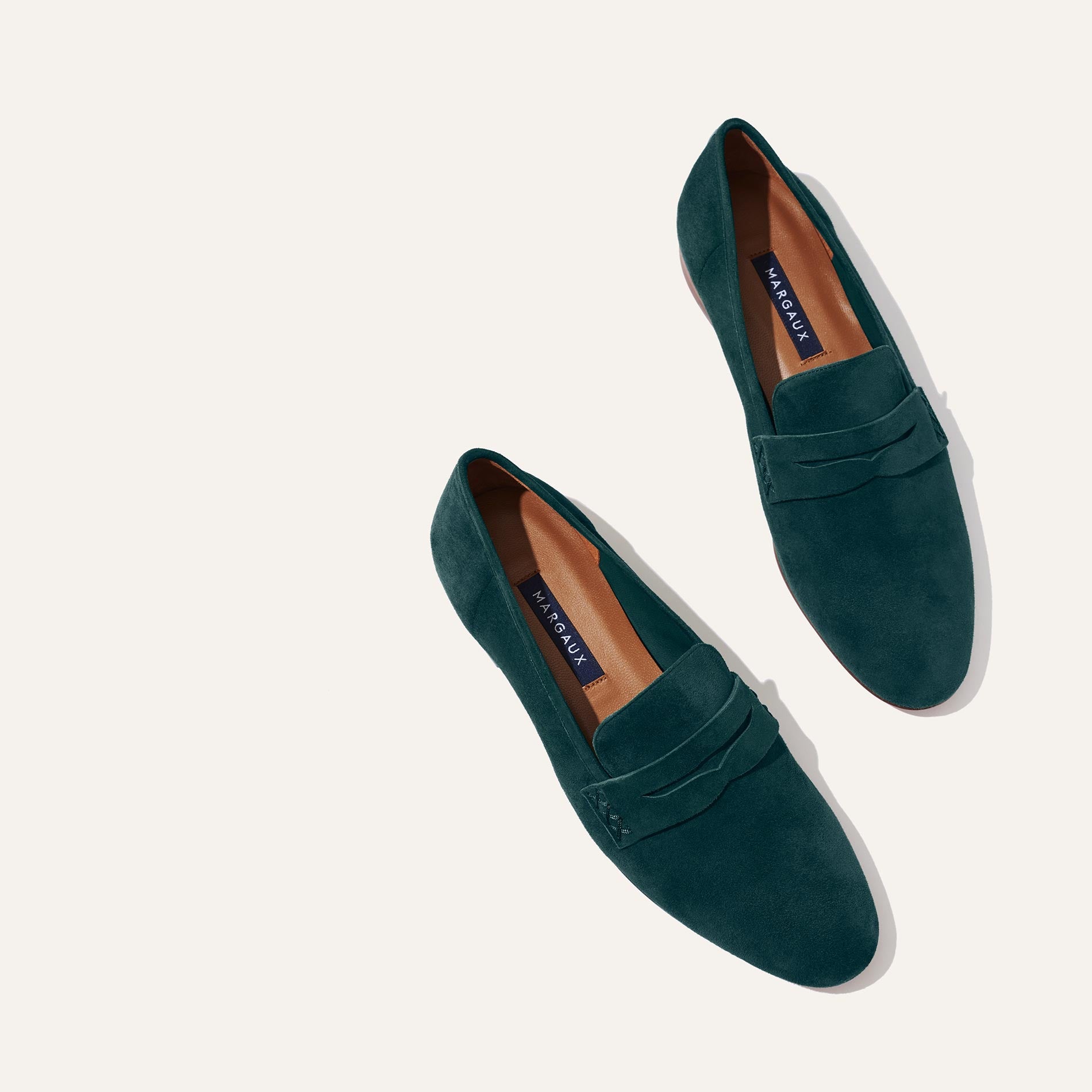 Margaux's classic and comfortable Penny loafer, made in Spain from soft, emerald green Italian suede 