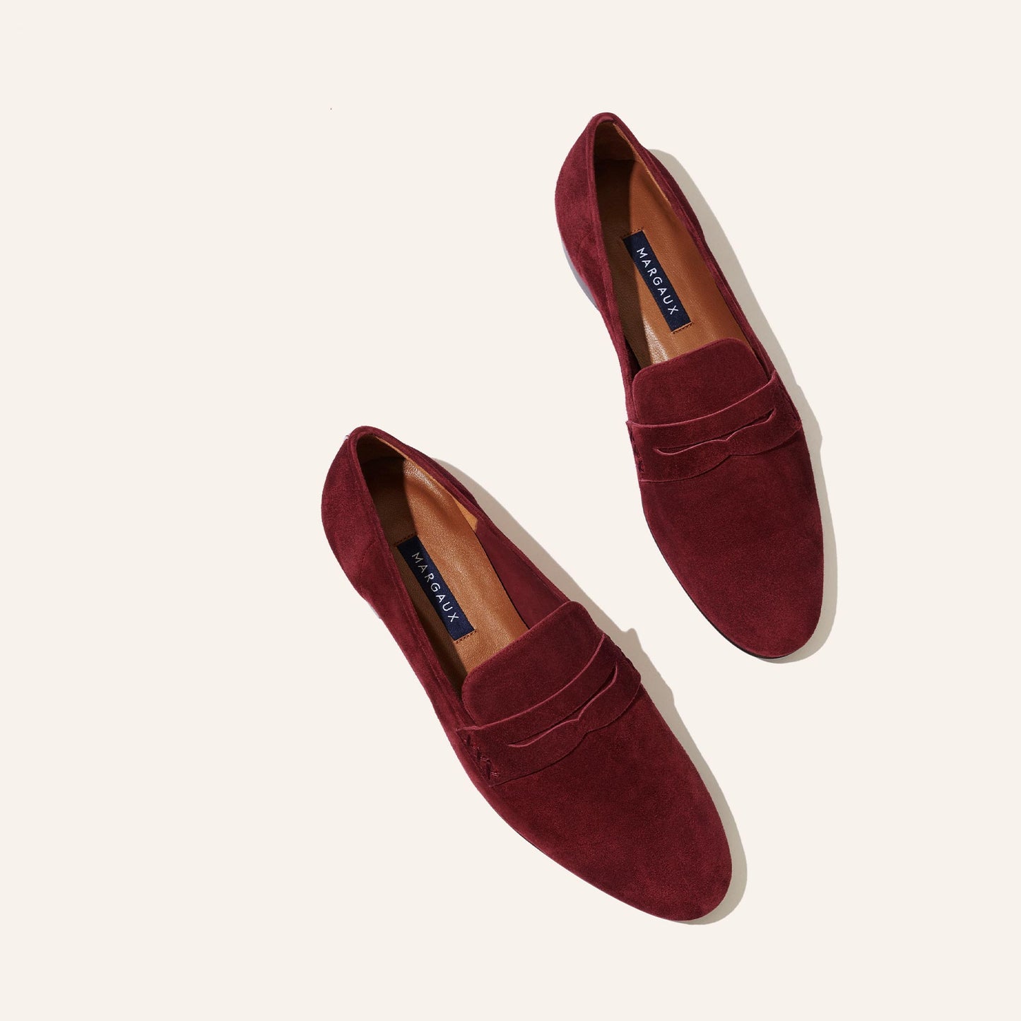 Margaux's classic and comfortable Penny loafer, made in Spain from soft, garnet red Italian suede 