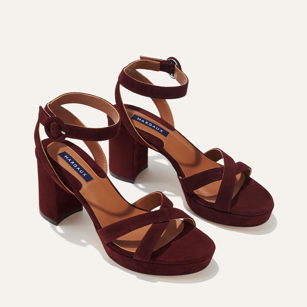 The Platform Sandal - Bordeaux Suede by margaux-development features block heels, ankle and crisscross toe straps, tan insoles, and a comfortable, elevated design in rich burgundy suede.