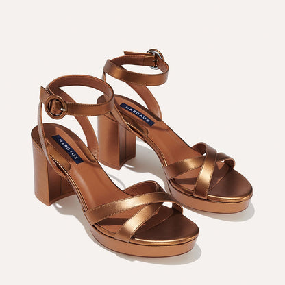 The Platform Sandal - Bronze Nappa by margaux-development features block heels, crisscross toe straps, and ankle buckle closures for an elevated yet comfortable look perfect for all-day style.