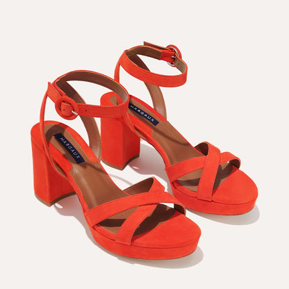 The Platform Sandal - Chili Suede by margaux-development: bright orange suede high-heeled sandals with thick block heels, crisscross front straps, ankle straps with round buckles, and brown insoles.