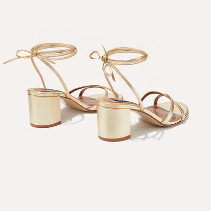 The Soho Sandal - Champagne Nappa by margaux-development features gold block heels, ankle straps, and open toes, shown on a white background from back and side views—perfect as your new summer staple.