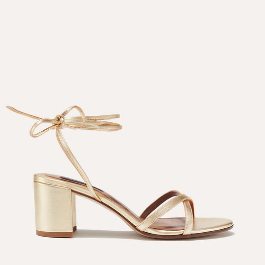 Margaux's strappy Soho Sandal with ankle ties, made in Spain from soft, champagne metallic nappa leather