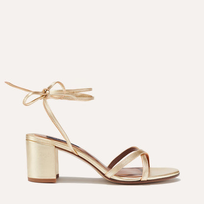 Margaux's strappy Soho Sandal with ankle ties, made in Spain from soft, champagne metallic nappa leather