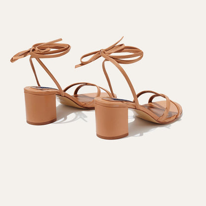 The Soho Sandal in Desert Nappa, featuring thin, flattering straps with a delicate ankle wrap, and a comfortable 2.5-inch block heel.