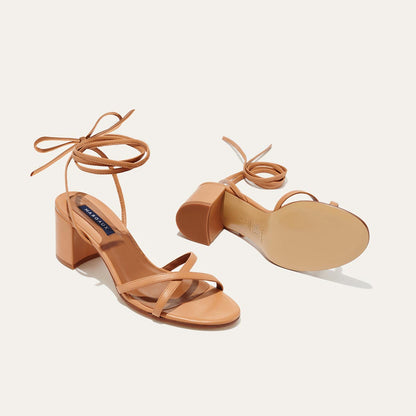The Soho Sandal in Desert Nappa, featuring thin, flattering straps with a delicate ankle wrap, and a comfortable 2.5-inch block heel.